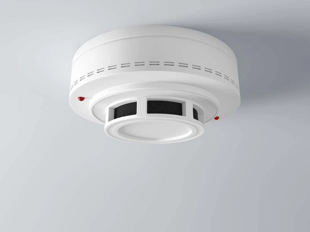 BTM Electrical & Air electrician installing a smoke alarm in a Gold Coast home