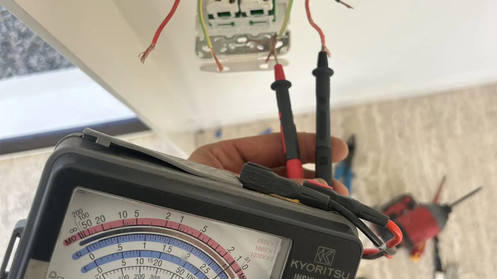 Licensed electrician carrying out maintenance on a Gold Coast property